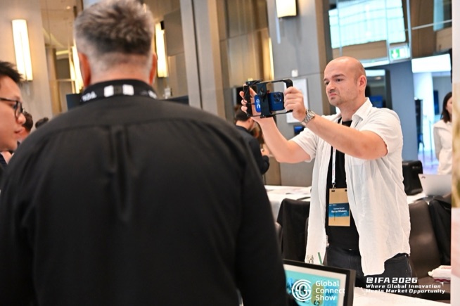An attendee films a demo on a smartphone at GCS IFA 2026